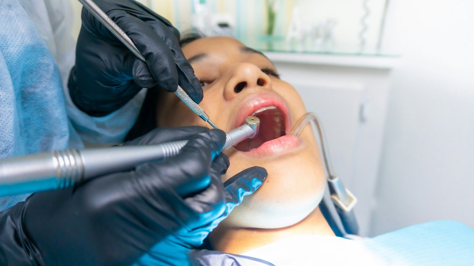 Dentist treating a patient in the dental chair